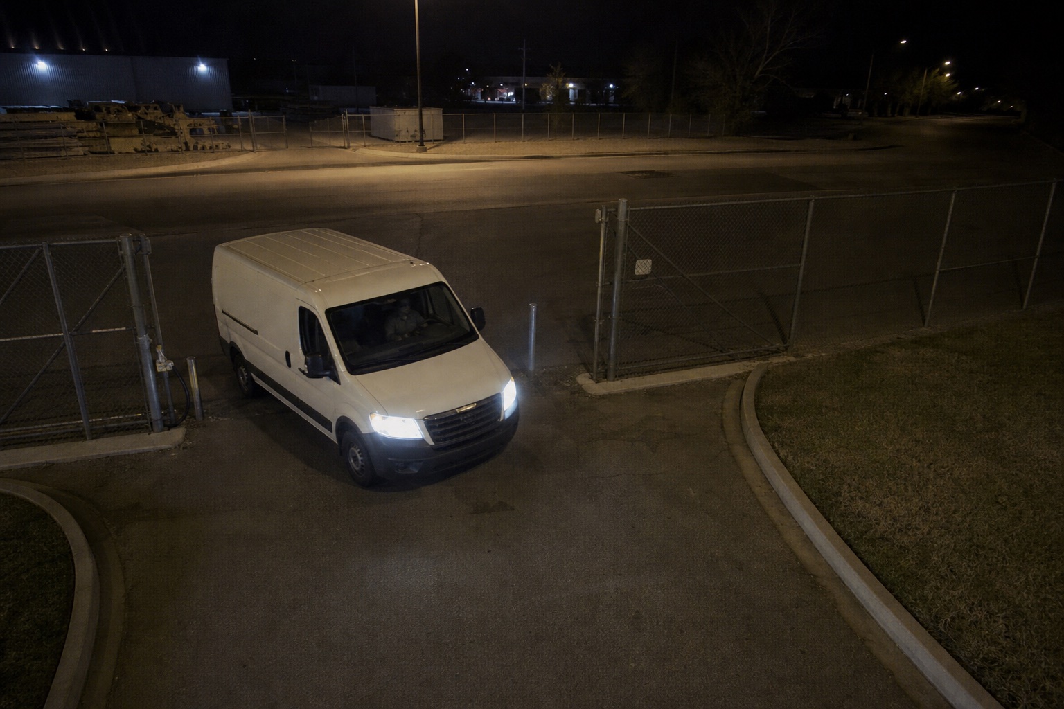 Cargo van entering a gate at night